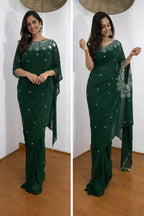 Woman wearing a green saree with silver embroidery in two different poses against a white wall.